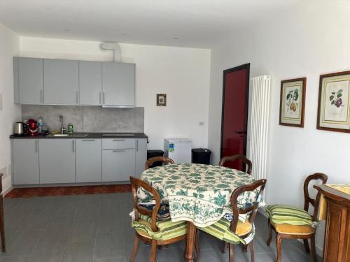 a kitchen with a table and chairs and a table and a kitchen at Casa Giorgio in Malnate