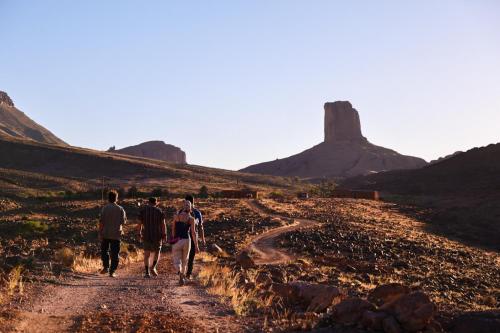 a group of people walking down a dirt road at Land of dreams in Nkob
