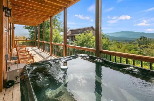 a hot tub on the deck of a house at Two Mountain Cabins with Views & Hot Tub Fun in Gatlinburg