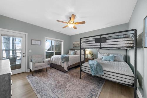 a bedroom with two bunk beds and a ceiling fan at Bluebird Sanctuary w Stunning Sunset Views Sleeps 28 in Big Sandy
