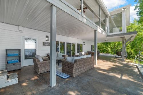 an outdoor patio with couches and a deck at Bluebird Sanctuary w Stunning Sunset Views Sleeps 28 in Big Sandy