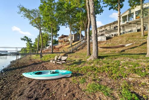 a blue kayak laying on the ground near the water at Bluebird Sanctuary w Stunning Sunset Views Sleeps 28 in Big Sandy