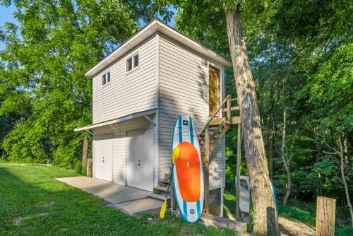 a house with a surfboard next to a house at Bluebird Sanctuary w Stunning Sunset Views Sleeps 28 in Big Sandy