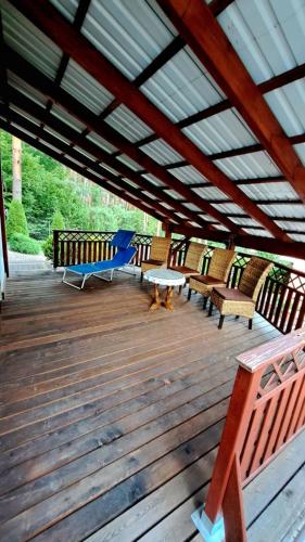 a wooden deck with benches and tables on it at Zofia in Struga