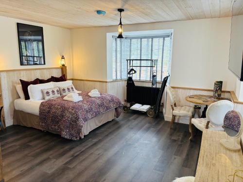 a bedroom with a bed and a table and a chair at St Oswalds Estate Lodges in Whitby