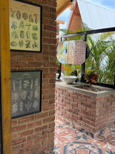 a brick wall with a sign on a patio at Chalet casa colibrí in Melgar