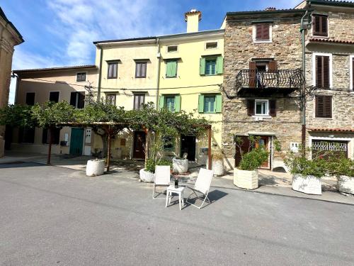 a group of chairs sitting in front of a building at Casa Valentina in Piran