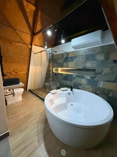 a bathroom with a white tub in a room at Chalet casa colibrí in Melgar
