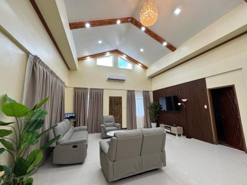 a living room with couches and a tv at International Haven Barili in Barili