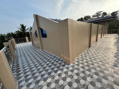 a house with a tile floor and a fence at International Haven Barili in Barili