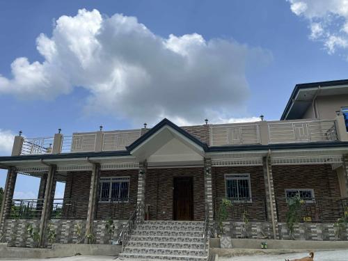 a brick house with stairs in front of it at International Haven Barili in Barili