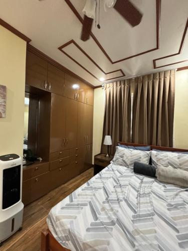 a bedroom with a large bed and a television at International Haven Barili in Barili