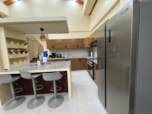 a kitchen with a counter and a refrigerator at International Haven Barili in Barili