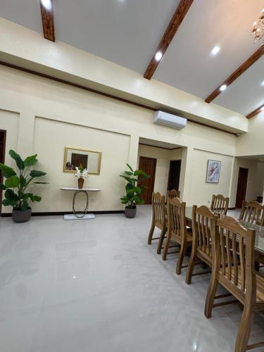a room with a table and chairs and a table and a table at International Haven Barili in Barili