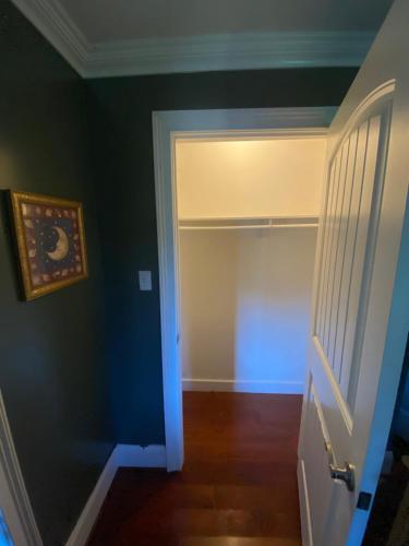 a hallway with a door leading to a closet at Room Rentals at Tenady in Greer