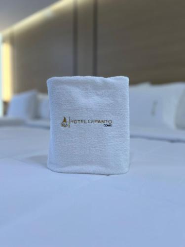 a white towel sitting on top of a bed at Hotel Lepanto Reforma in Mexico City