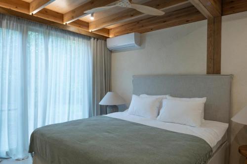 a bedroom with a large bed with a wooden ceiling at Zarichka in Zachepilovka