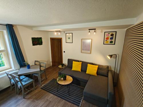 a living room with a couch and a table at Vila Mezi Časy in Trutnov