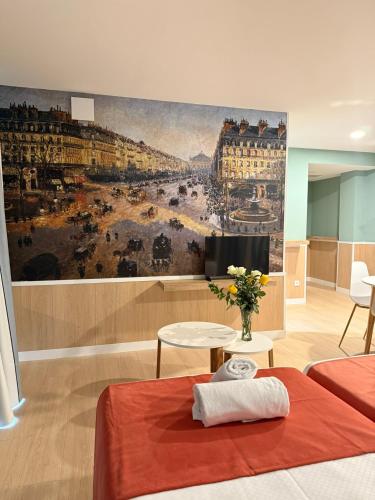 a room with a painting of a city at Luxury Singular Pensión Estudios Blue in Santiago de Compostela