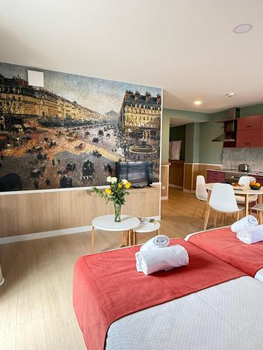 two beds in a room with a painting on the wall at Luxury Singular Pensión Estudios Blue in Santiago de Compostela