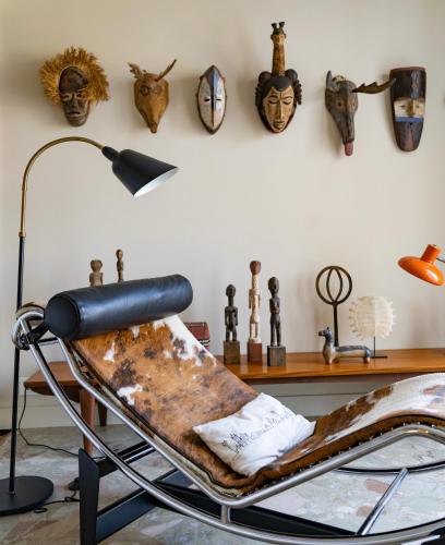 a room with a chair and masks on the wall at Chez Francesca in Bordeaux