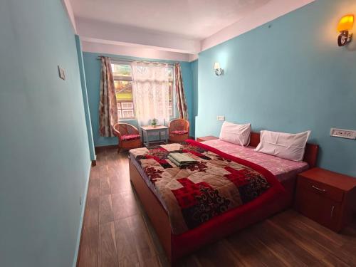 a bedroom with a bed and a window at Hotel Little Hut - 550 mts from Mall Road in Darjeeling