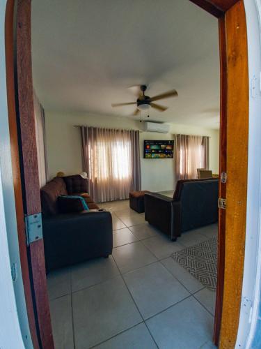 a living room with two couches and a ceiling fan at Casa Costamar 