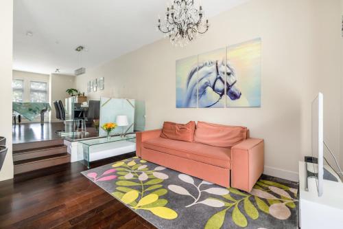a living room with a couch and a painting of a horse at Family-Friendly 5BR Home Near UBC in Vancouver