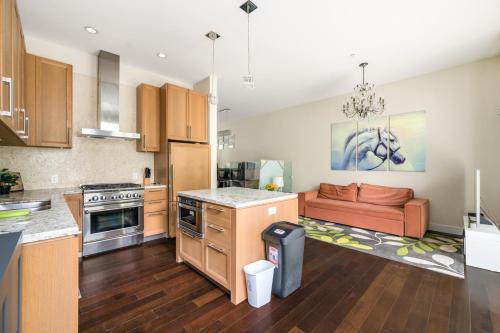 an open kitchen and living room with a couch at Family-Friendly 5BR Home Near UBC in Vancouver