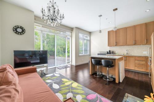 a living room with a kitchen with a couch at Family-Friendly 5BR Home Near UBC in Vancouver