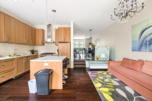 a kitchen and living room with a red couch at Family-Friendly 5BR Home Near UBC in Vancouver