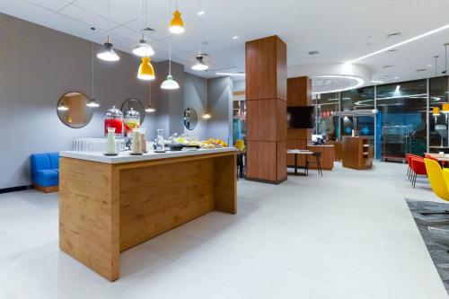 a lobby with a counter with drinks on it at Tru By Hilton Chillan Ferrat in Chillán
