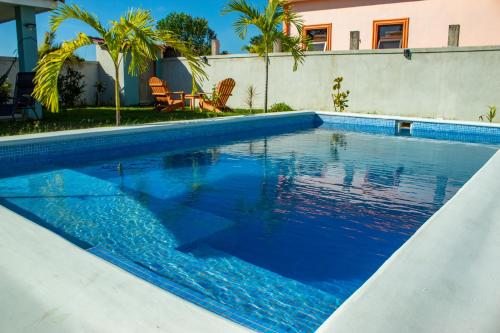 a swimming pool with blue water in front of a house at Casa Costamar 