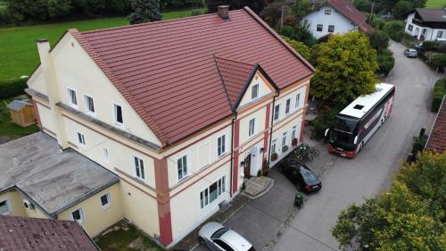 an aerial view of a large house with a red roof at Gasthaus Jungwirth - Family Boutique Pension in Wanghausen