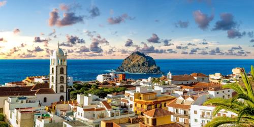 a view of a city with a church and the ocean at EDEN RENTALS Atogo Cozy Apartment in Granadilla de Abona