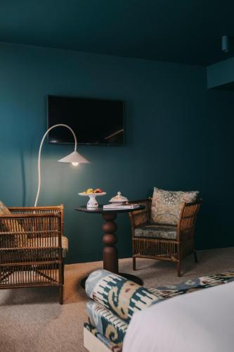a room with a table and chairs and a lamp at Torel Terra Brava in Angra do Heroísmo