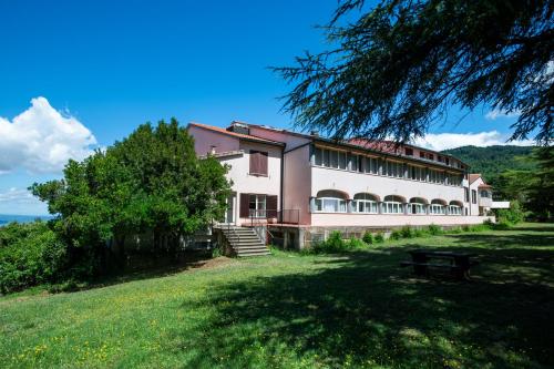 a large building on top of a grassy field at Toscana Wellness Resort in Arcidosso