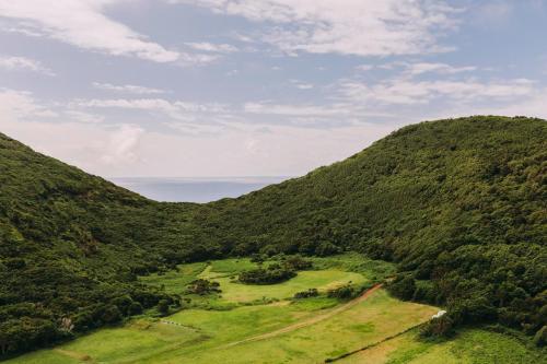 an aerial view of a mountain valley with a road at Torel Terra Brava in Angra do Heroísmo