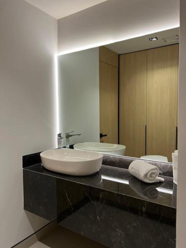 a bathroom with a sink and a mirror at Hotel Lepanto Reforma in Mexico City