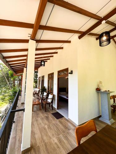 a patio with wooden ceilings and a table and chairs at Shiimmer - Ella in Ella