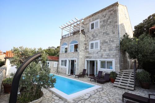 a house with a swimming pool in front of it at Villa Imperial View in Zaton