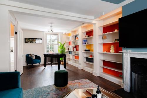 a living room with a table and a fireplace at Design Haven! Big Group-Friendly 4BR City Escape in Waterloo's Coolest Corner in London