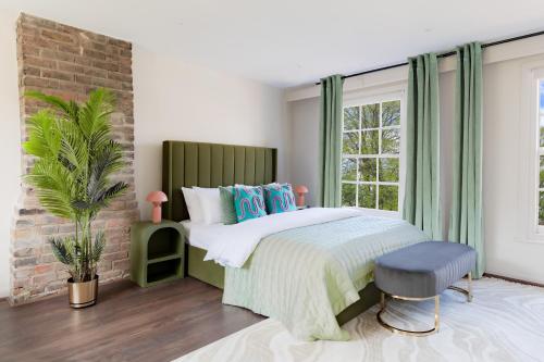 a bedroom with a bed and a brick wall at Design Haven! Big Group-Friendly 4BR City Escape in Waterloo's Coolest Corner in London