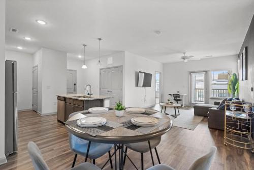 a kitchen and living room with a table and chairs at Upscale King 2BR Suite Mins Uptown Charlotte in Charlotte