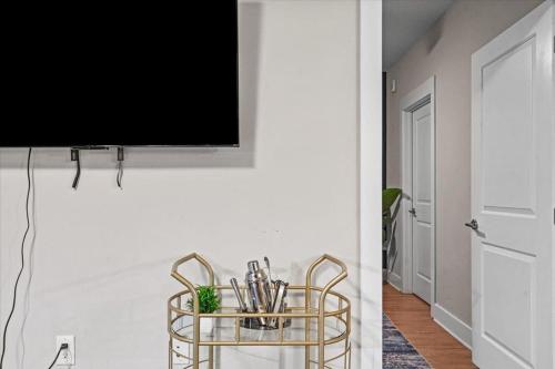 a living room with a tv on a white wall at Upscale King 3BR Suite to Uptown Charlotte in Charlotte
