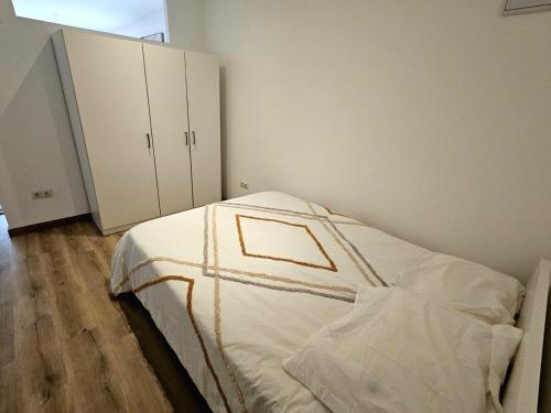 a bedroom with a bed with white sheets at Peaceful Poolside Studio 20min from BCN in Sant Cugat del Vallès