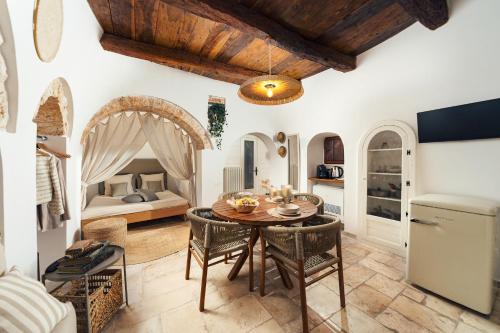 a kitchen and dining room with a table and chairs at Trullo Anteros in Alberobello