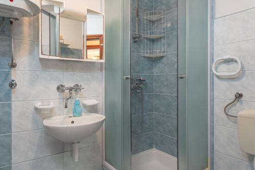 a small bathroom with a sink and a shower at Apartments Darko in Vir