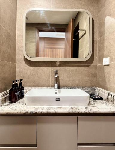 a bathroom sink with a large mirror above it at Hami LakeView Service Apartment in Hanoi