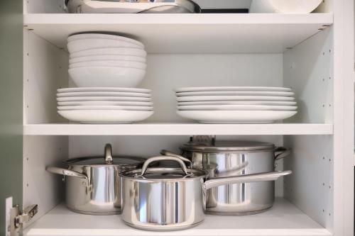 a cupboard with plates and pans and dishes at Apartment Combaz 4 in Mellet